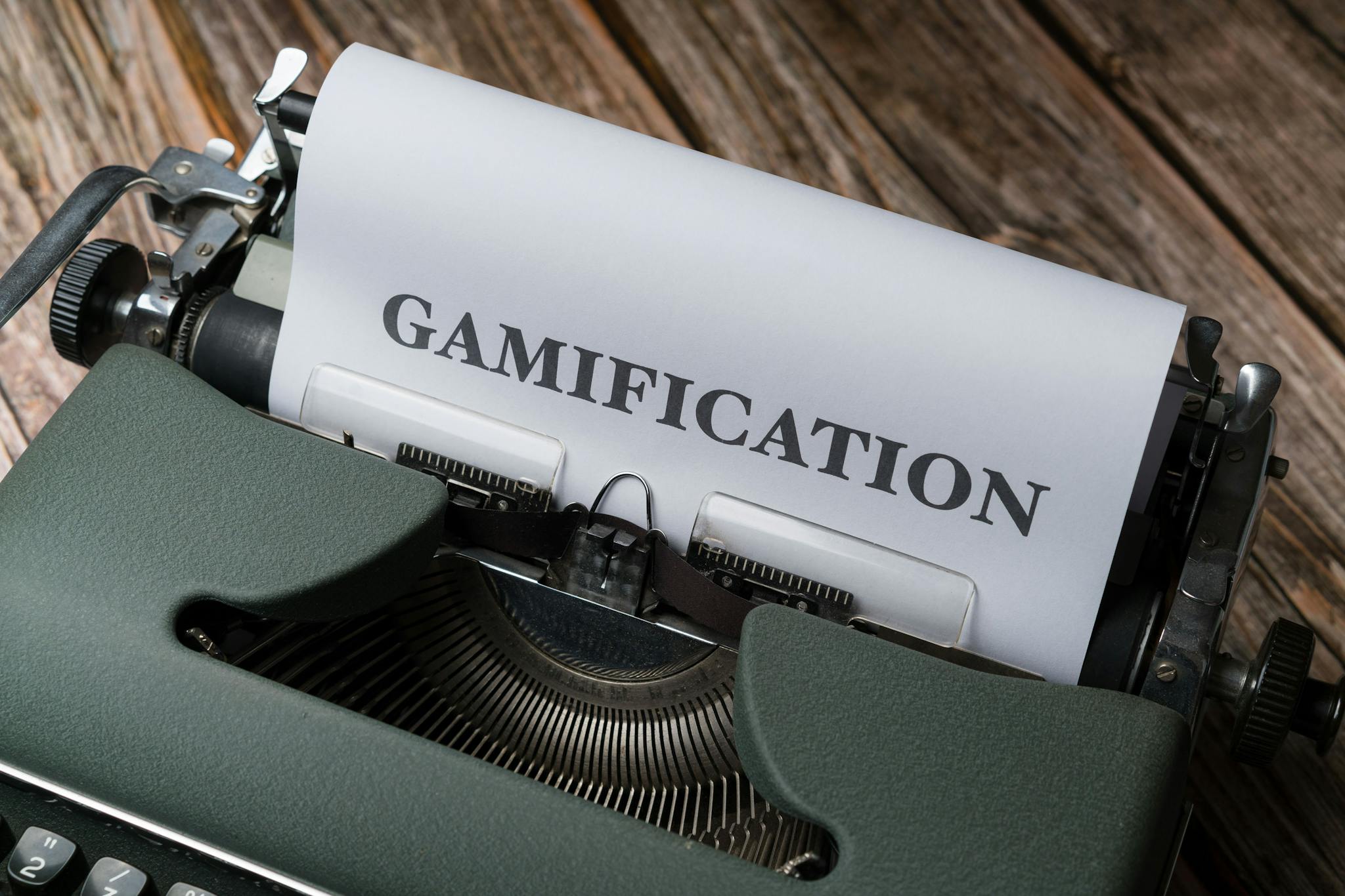 Close-up of a vintage typewriter with 'Gamification' typed on paper, emphasizing game-based concepts.
