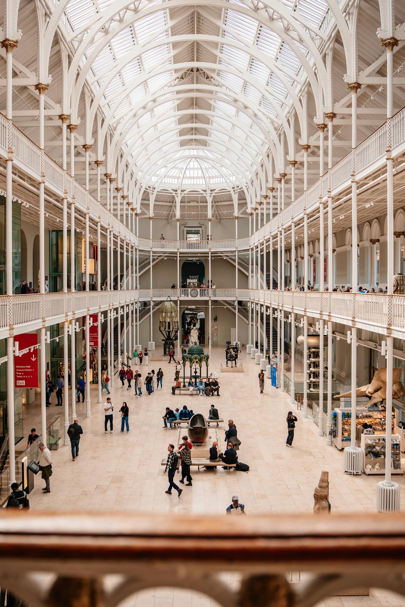 Stunning architectural view of a grand museum interior filled with visitors.